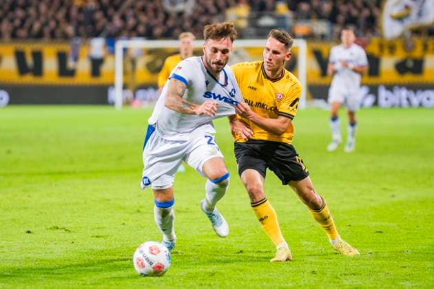 04 10 2025, xomx, Soccer 2 Bundesliga, Dynamo Dresden Karlsruher SC v l Fabian Schleusener Karlsruher SC and Konrad Faber Dynamo Dresden in a duel on the ball DFL DFB REGULATIONS PROHIBIT ANY USE OF PHOTOGRAPHS as IMAGE SEQUENCES and or QUASI VIDEO Dresden