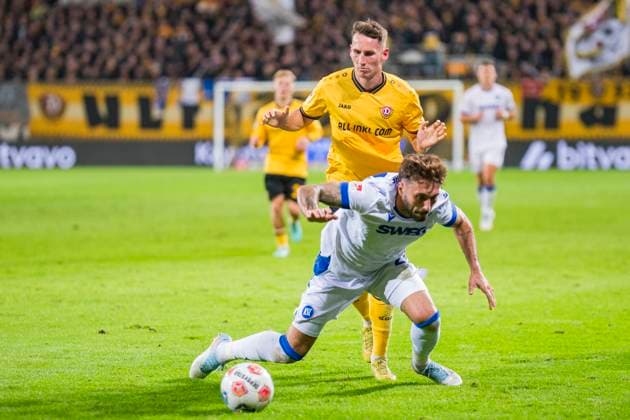 04 10 2025, xomx, Soccer 2 Bundesliga, Dynamo Dresden Karlsruher SC v l Fabian Schleusener Karlsruher SC and Konrad Faber Dynamo Dresden in a duel on the ball DFL DFB REGULATIONS PROHIBIT ANY USE OF PHOTOGRAPHS as IMAGE SEQUENCES and or QUASI VIDEO Dresden