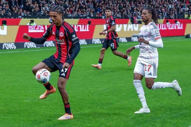 left to right Jean Matteo Bahoya 19 Eintracht Frankfurt in front of Michael Olise 17 FC Bayern Muenchen on the ball, Can Uzun 42 Eintracht Frankfurt in the background watching, Eintracht Frankfurt vs FC Bayern Muenchen, DFL, Bundesliga, Season 2025 2026, Deutsche Bank Park, Hinrunde, 6 Spieltag, 04 10 2025 DFB regulations prohibit any use of photographs as image sequences and or quasi video Frankfurt Hessen Germany Copyright: xkolbert-press MartinxAgüerax