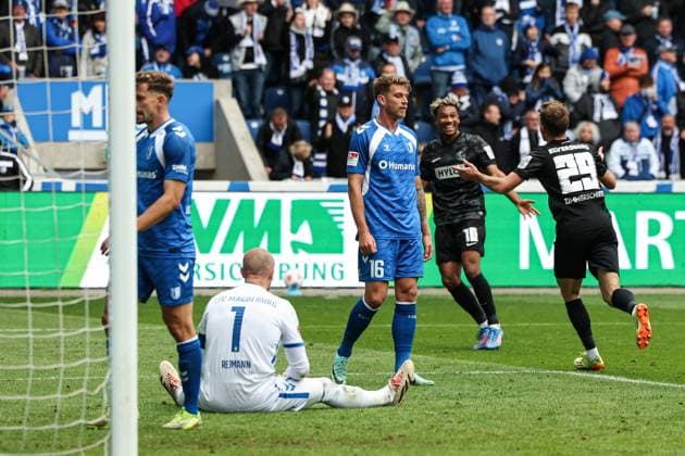 Marcus Mathisen 1 FC Magdeburg,16 and goalkeeper Dominik Reimann 1 FC Magdeburg,1 Goalscorer Tom Zimmerschied SV Elversberg,29 scores to 0 2 2 Soccer Bundesliga Season 2025 2026 1 FC Magdeburg vs SV 07 Elversberg at the Avnet Arena in Magdeburg Action,Soccer,Man,Men,Germany,05 10 2025