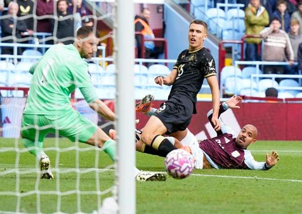 Birmingham, England, 5th October 2025. Donyell Malen of Aston Villa (R) scores the opening goal during the Aston Villa vs Burnley Premier League match at Villa Park, Birmingham. Picture credit should read: Andrew Yates Sportimage EDITORIAL USE ONLY. No use with unauthorised audio, video, data, fixture lists, club league logos or live services. Online in-match use limited to 120 images, no video emulation. No use in betting, games or single club league player publications. SPI_012_VILLA_BURNLEY SPI-4198-0011