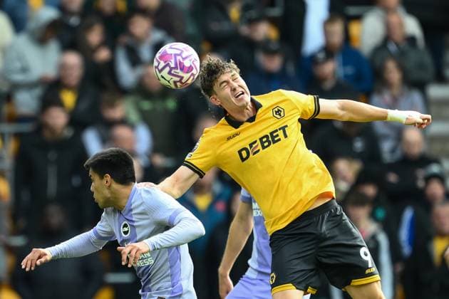 Wolverhampton, England, 5th October 2025. Joergen Strand Larsen of Wolverhampton Wanderers jumps up to win the high ball during the Wolverhampton Wanderers vs Brighton and Hove Albion Premier League match at Molineux, Wolverhampton. Picture credit should read: Craig Thomas Sportimage EDITORIAL USE ONLY. No use with unauthorised audio, video, data, fixture lists, club league logos or live services. Online in-match use limited to 120 images, no video emulation. No use in betting, games or single club league player publications. SPI_045_CT_Wolves_v_Brighton SPI-4200-0045