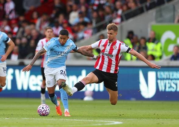 5th October 2025; Gtech Community Stadium, Brentford, London, England; Premier League Football, Brentford versus Manchester City; Kristoffer Ajer of Brentford tackles Savinho of Manchester City  JohnxPatrickxFletcher