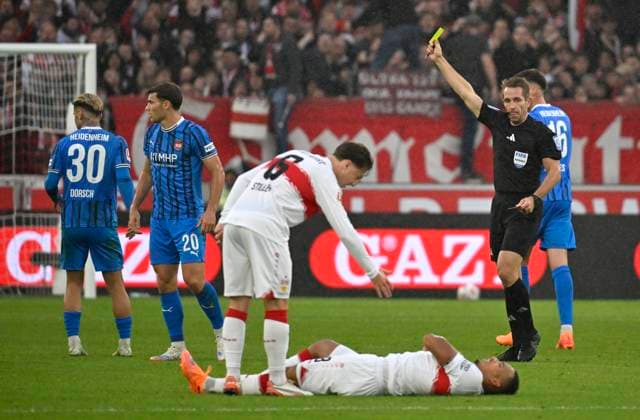 Referee Referee Tobias Stieler shows Luca Kerber 1 FC Heidenheim 1846 FCH 20 yellow card yellow caution for foul on Jamie Leweling VfB Stuttgart 18 injured Injury on the groundAngelo Stiller VfB Stuttgart 06 VfB Stuttgart vs 1 FC Heidenheim FCH 05 10 2025 DFL REGULATIONS PROHIBIT ANY USE OF PHOTOGRAPHS AS IMAGE SEQUENCES AND OR QUASI VIDEO VfB Stuttgart vs 1 FC Heidenheim FCH