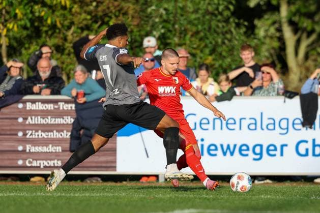 in duel, action, with Paul Philipp Besong 17 SSV Ulm 1846 , Mads Pedersen 3 FC Augsburg , FC Augsburg vs SSV Ulm 1846, Soccer, Test match, 08 10 2025 Burgau Bayern Germany Copyright: xkolbert-press ChristianxKolbertx