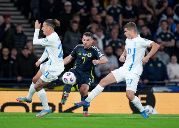 John McGinn of Scotland passes the ball between Kostas Tsimikas & Christos Mouzakitis of Greece. Scotland v Greece, FIFA 2026 World Cup Qualifying, Group C, Football, Hampden Park, Glasgow, Scotland, UK - 09 Oct 2025Glasgow Hampden Park United Kingdom EDITORIAL USE ONLY No use with unauthorised audio, video, data, fixture lists, club league logos or live services. Online in-match use limited to 120 images, no video emulation. No use in betting, games or single club league player publications.  Copyright: xStuartxWallace Shutterstockx 15522896er