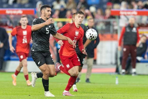9th October 2025; Stadion Slaski, Chorzow, Poland; International Football, friendly match, Poland versus New Zealand; Michael Boxall (NZA) and Krzysztof Piatek (POL) tussle for possession  FotoxOlimpik