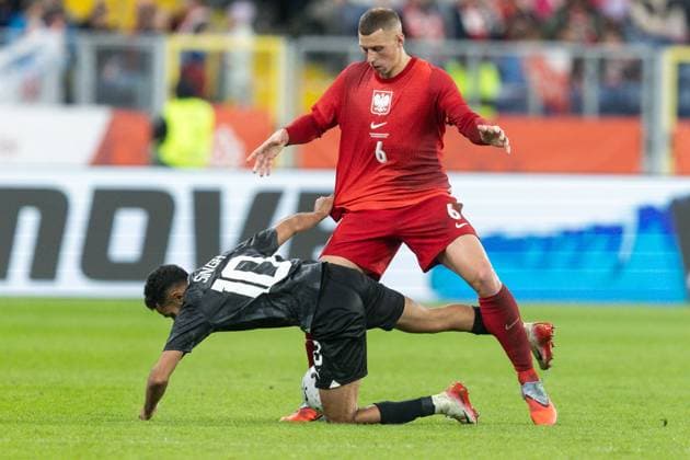 9th October 2025; Stadion Slaski, Chorzow, Poland; International Football, friendly match, Poland versus New Zealand; Sarpreet Snigh (NZA) goes down under pressure from Jakub Piotrowski (POL)  FotoxOlimpik