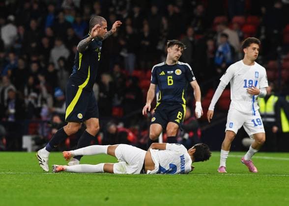 UK: Scotland v Greece, World Cup Qualifier, at Hampden Park in Glasgow, Scotland on 09 October 2025 Scotland v Greece, World Cup Qualifier, at Hampden Park in Glasgow, Scotland on 09 October 2025 Giorgos Vagiannidis (Greece) crashes to the ground under pressure from Lyndon Dykes (Scotland) Glasgow Hampden Park Strathclyde Scotland Copyright: xGerxHarleyx