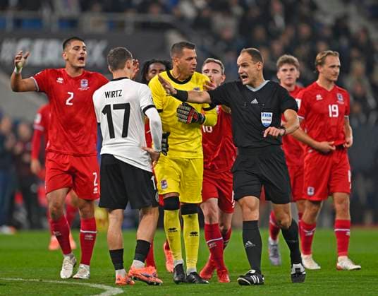 10 10 2025, Football World Cup Qualification Europe 2025 26, Matchday 7, Germany Luxembourg, in the PreZero Arena Sinsheim Referee Nenad Minakovic Serbia Goalkeeper Anthony Moris Luxembourg and Seid Korac Luxembourg discuss