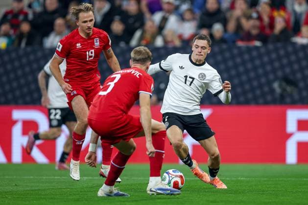 10 10 2025, Football, International match, Germany Luxembourg, UEFA World Cup Qualification, 2025 2026, Group A, PreZero Arena in Sinsheim Florian Wirtz GER 17 in duel against Enes Mahmutovic LUX 03 DFB regulations prohibit any use of photographs as image sequences and or quasi video Baden Württemberg Germany