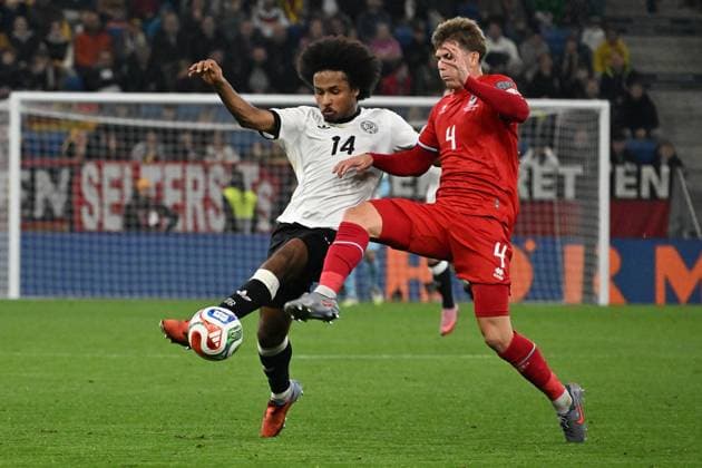 10 10 2025, xsltx, Football World Cup Qualification 2026, Germany Luxembourg v l Karim Adeyemi German National Football Team DFB Florian Bohnert Luxembourg duel, action, action, battle for the ball DFL DFB REGULATIONS PROHIBIT ANY USE OF PHOTOGRAPHS as IMAGE SEQUENCES and or QUASI VIDEO Sinsheim