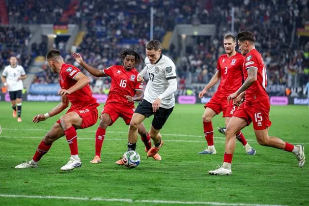 10 10 2025, Football, International match, Germany Luxembourg, UEFA World Cup Qualification, 2025 2026, Group A, PreZero Arena in Sinsheim Florian Wirtz GER 17 in a duel against Olivier Thill LUX 15 Seid Korac LUX 02 Enes Mahmutovic LUX 03 Leandro Barreiro LUX 16 DFB regulations prohibit any use of photographs as image sequences and or quasi video Baden Württemberg Germany
