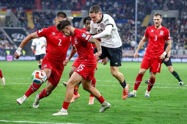 10 10 2025, Football, International match, Germany Luxembourg, UEFA World Cup Qualification, 2025 2026, Group A, PreZero Arena in Sinsheim Florian Wirtz GER 17 in a duel against Olivier Thill LUX 15 Seid Korac LUX 02 Enes Mahmutovic LUX 03 Leandro Barreiro LUX 16 DFB regulations prohibit any use of photographs as image sequences and or quasi video Baden Württemberg Germany