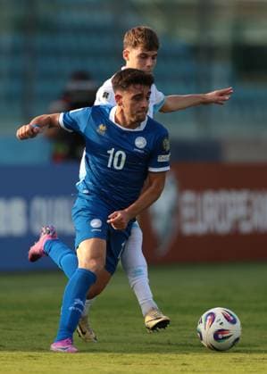 Serravalle, Italy, 12th October 2025. Loizos Loizou of Cyprus takes on Nicko Sensoli of San Marino during the San Marino vs Cyprus FIFA World Cup, WM, Weltmeisterschaft, Fussball European Qualifying match at San Marino Stadium, Serravalle. Picture credit should read: Jonathan Moscrop Sportimage EDITORIAL USE ONLY. No use with unauthorised audio, video, data, fixture lists, club league logos or live services. Online in-match use limited to 120 images, no video emulation. No use in betting, games or single club league player publications. SPI_009_JM_SANMARINO_CYPRUS_EQ SPI-4191-0009