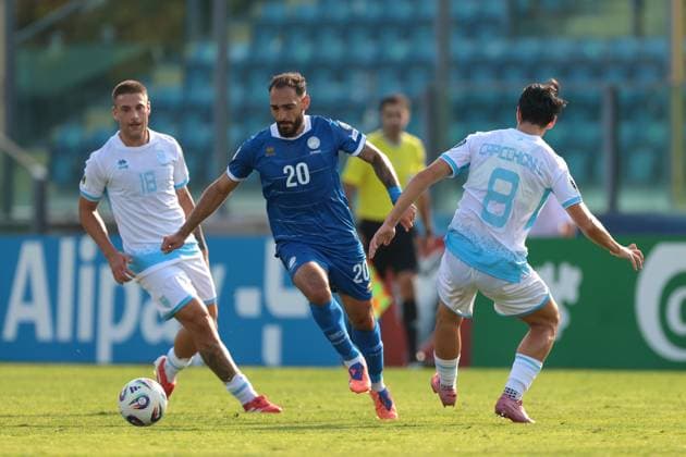 Serravalle, Italy, 12th October 2025. Grigoris Kastanos of Cyprus takes on Samuele Zannoni and Lorenzo Capicchioni of San Marino during the San Marino vs Cyprus FIFA World Cup, WM, Weltmeisterschaft, Fussball European Qualifying match at San Marino Stadium, Serravalle. Picture credit should read: Jonathan Moscrop Sportimage EDITORIAL USE ONLY. No use with unauthorised audio, video, data, fixture lists, club league logos or live services. Online in-match use limited to 120 images, no video emulation. No use in betting, games or single club league player publications. SPI_025_JM_SANMARINO_CYPRUS_EQ SPI-4191-0025