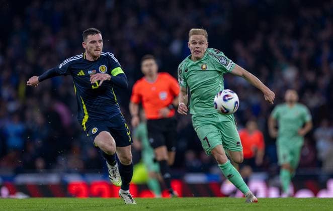 12th October 2025; Hampden Park, Glasgow, Scotland; World Cup Qualifiers International Football, Scotland versus Belarus; Andy Robertson of Scotland and Evgeni Malashevich of Belarus chase the ball down  VagelisxGeorgariou