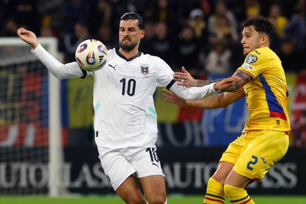 (251013) -- BUCHAREST, Oct. 13, 2025 -- Romania s Andrei Ratiu (R) vies with Austria s Florian Grillitsch during the 2026 FIFA World Cup, WM, Weltmeisterschaft, Fussball group H qualifying football match between Romania and Austria at the Arena Nationala stadium in Bucharest, Romania, Oct. 12, 2025. (Photo by Xinhua) (SP)ROMANIA-BUCHAREST-FOOTBALL-WORLD CUP QUALIFIER-ROMANIA VS AUSTRIA CristianxCristel 