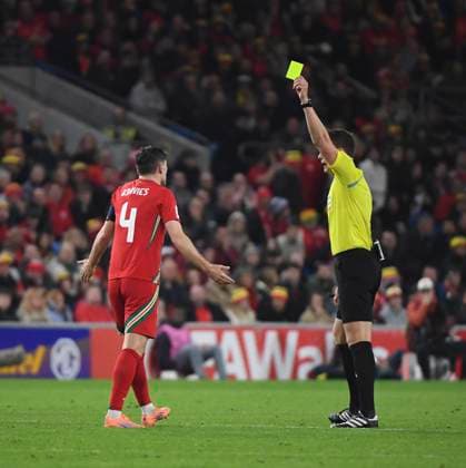 13th October 2025; Cardiff City Stadium, Cardiff, Wales; FIFA World Cup, WM, Weltmeisterschaft, Fussball Qualifying Group J International Football, Wales versus Belgium; Ben Davies of Wales receives a yellow card from the referee, Daniel Siebert  AledxHopkins