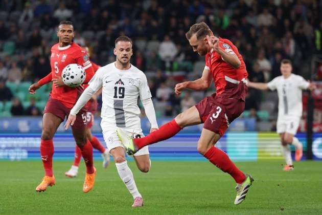 (251014) -- LJUBLJANA, Oct. 14, 2025 -- Silvan Widmer (R) of Switzerland competes during the World Cup 2026 European Qualifiers Group B football match between Slovenia and Switzerland in Ljubljana, Slovenia, Oct. 13, 2025. (Photo by Xinhua) (SP)SLOVENIA-LJUBLJANA-FOOTBALL FIFA World Cup, WM, Weltmeisterschaft, Fussball EUROPEAN QUALIFIERS-SLOVENIA VS SWITZERLAND ZeljkoxStevanic 
