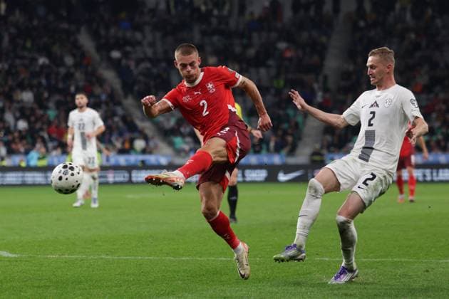 (251014) -- LJUBLJANA, Oct. 14, 2025 -- Miro Muheim (L) of Switzerland shoots during the World Cup 2026 European Qualifiers Group B football match between Slovenia and Switzerland in Ljubljana, Slovenia, Oct. 13, 2025. (Photo by Xinhua) (SP)SLOVENIA-LJUBLJANA-FOOTBALL FIFA World Cup, WM, Weltmeisterschaft, Fussball EUROPEAN QUALIFIERS-SLOVENIA VS SWITZERLAND ZeljkoxStevanic 