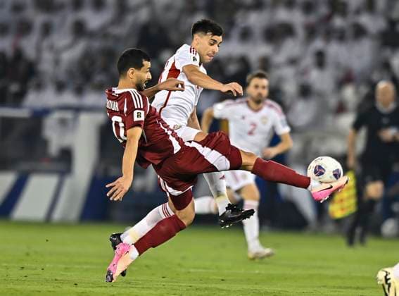UQATAR v NITED ARAB EMIRATES-2026 FIFA World Cup, WM, Weltmeisterschaft, Fussball ASIAN QUALIFIER PLAYOFFS Boualem Khoukhi (L) of Qatar and Nicolas Gimenez of United Arab Emirates in action during the FIFA World Cup 2026 AFC Asian qualifiers playoffs group A match between Qatar and United Arab Emirates at Jassim Bin Hamad Stadium in Doha, Qatar, on October 14, 2025. DOHA Qatar Copyright: xNOUSHADx