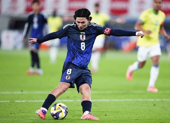 Football: Friendly between Japan and Brazil Japan s Takumi Minamino scores in the second half of an international football friendly against Brazil at Ajinomoto Stadium in Chofu, Tokyo, on Oct. 14, 2025.  A14AA0004942049P