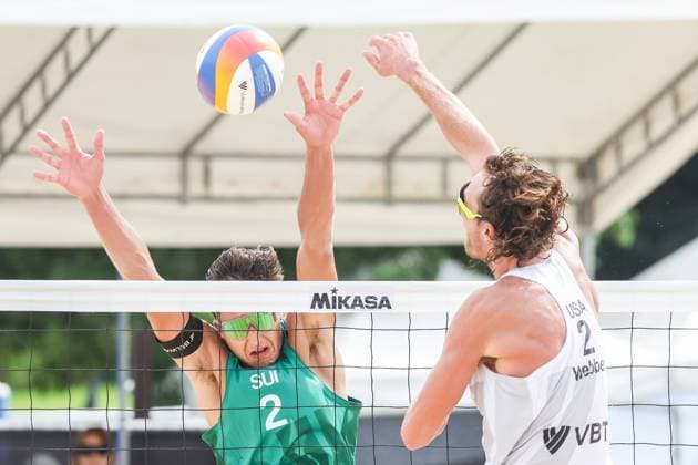 (251015) -- LAGUNA PROVINCE, Oct. 15, 2025 -- Logan Webber (R) of the United States spikes the ball against Luc Fluckiger of Switzerland during the men s qualification match between Hagen Smith Logan Webber of the United States and Florian Breer Luc Fluckiger of Switzerland at the Volleyball World Beach Pro Tour in Laguna Province, the Philippines, Oct. 15, 2025. ) (SP)THE PHILIPPINES-LAGUNA PROVINCE-VOLLEYBALL WORLD BEACH PRO TOUR ROUELLExUMALI 