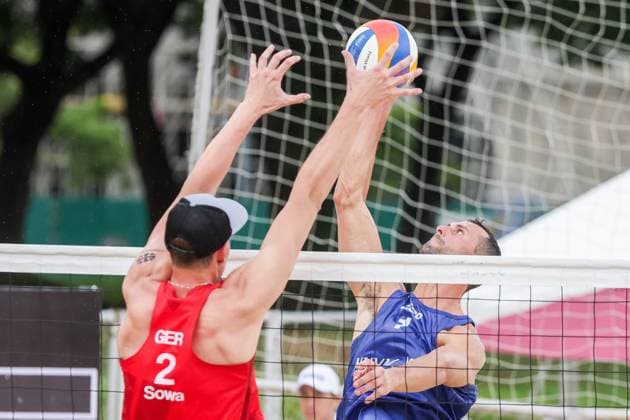 (251015) -- LAGUNA PROVINCE, Oct. 15, 2025 -- Nathan Matos (R) of Spain spikes the ball against Robin Sowa of Germany during the men s qualification match between Jonas Reindhardt Robin Sowa of Germany and Nathan Matos Pablo Perez Suarez of Spain at the Volleyball World Beach Pro Tour in Laguna Province, the Philippines, Oct. 15, 2025. ) (SP)THE PHILIPPINES-LAGUNA PROVINCE-VOLLEYBALL WORLD BEACH PRO TOUR ROUELLExUMALI 