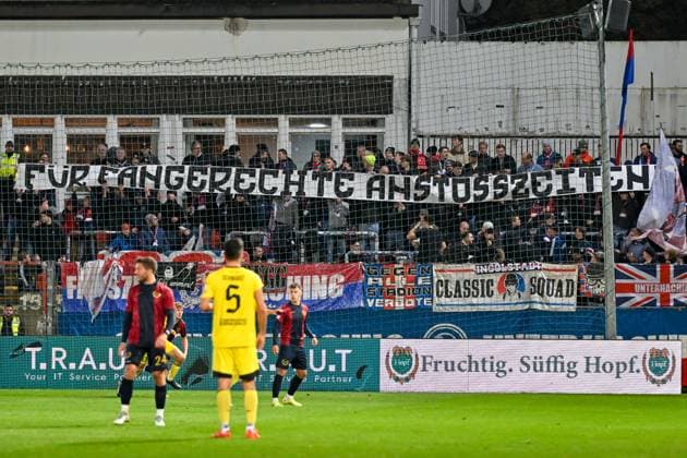 Unterhaching fans chant against the kick-off times and hold up a corresponding banner FÜR FANGERECHTE ANSTSTOSSZEITEN , fans, audience, spectators, mood, atmosphere, stadium, 17 10 2025, Unterhaching Germany , Football, Regionalliga Bayern, SpVgg Unterhaching SpVgg Bayreuth xslx