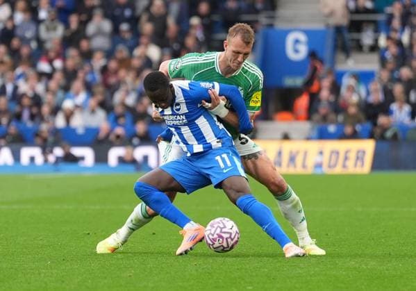 Yankuba Minteh of Brighton & Hove Albion held back by Dan Burn of Newcastle United. Brighton and Hove Albion v Newcastle United, Premier League, Football, American Express Community Stadium, Brighton, UK - 18 Oct 2025Brighton American Express Community Stadi United Kingdom EDITORIAL USE ONLY No use with unauthorised audio, video, data, fixture lists, club league logos or live services. Online in-match use limited to 120 images, no video emulation. No use in betting, games or single club league player publications.  Copyright: xSeanxRyan Shutterstockx 15544971bb