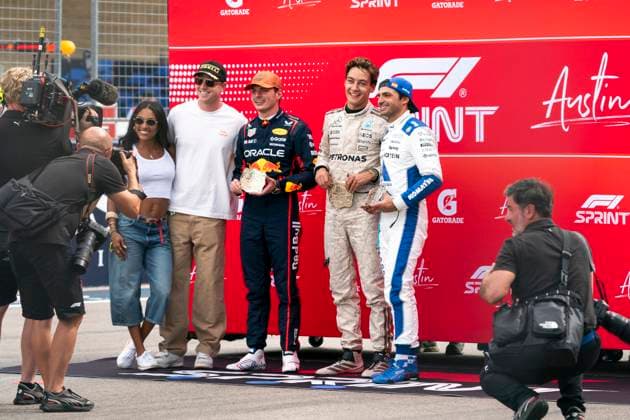 Dutch Formula One driver Max Verstappen of Red Bull Racing, British Formula One driver George Russell of Mercedes-AMG Petronas and Spanish Formula One driver Carlos Sainz Jr. of Williams Racing pose for a photo following the sprint race at the Formula One United States Grand Prix at the Circuit of the Americas in Austin, Texas on Saturday, October 18, 2025.  AUS2025101826 GREGxNASH