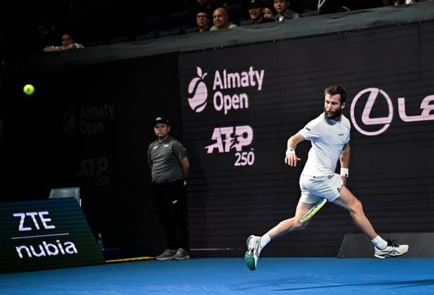 (251019) -- ALMATY, Oct. 19, 2025 -- Corentin Moutet of France hits a return during the men s singles semifinal match against Alex Michelsen of the United States at the ATP, Tennis Herren 250 Almaty Tennis Open in Almaty, Kazakhstan, on Oct. 18, 2025. ) (SP)KAZAKHSTAN-ALMATY-TENNIS-ALMATY OPEN-SEMIFINAL LixRenzi 
