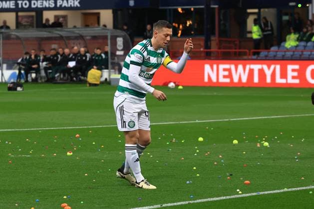 19th October 2025; Dens Park, Dundee, Scotland; Scottish Premiership Football, Dundee versus Celtic; Callum McGregor of Celtic helps clear the pitch after Celtic fans had disrupted the game by throwing balls on to get the game halted  DavidxYoung