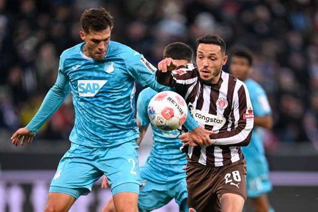 Soccer 1 Bundesliga FC St Pauli TSG Hoffenheim on 19 10 2025 at Millerntor Stadion in Hamburg Mathias Pereira Lage St Pauli in duel against Manolis Saliakas St Pauli MT