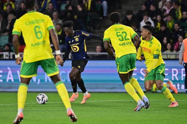 FOOTBALL : Nantes vs Lille - Ligue 1 - 19 10 2025 Felix Correia ( 27 - Lille ) and Kelvin Amian Adou ( 98 - Nantes )during the Ligue 1match between FC Nantes and Lille OSC at Stade de la Beaujoire on October 19, 2025 in Nantes, France. ( Photo by Federico Pestellini PsnewZ ) - NantesFrance  Copyright: xFedericoxPestellinix