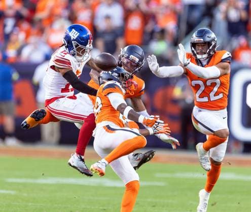 October 19, 2025, Denver, Colorado, USA: Giants WR WANÃ¢â‚¬â ¢DALE ROBISON has his pass batted away in Broncos traffice during the 2nd. Half at Empower Field at Mile High Sunday afternoon. Broncos beat the Giants 33-32. Denver USA - ZUMAav4_ 20251019_zaf_av4_010 Copyright: xHectorxAcevedox