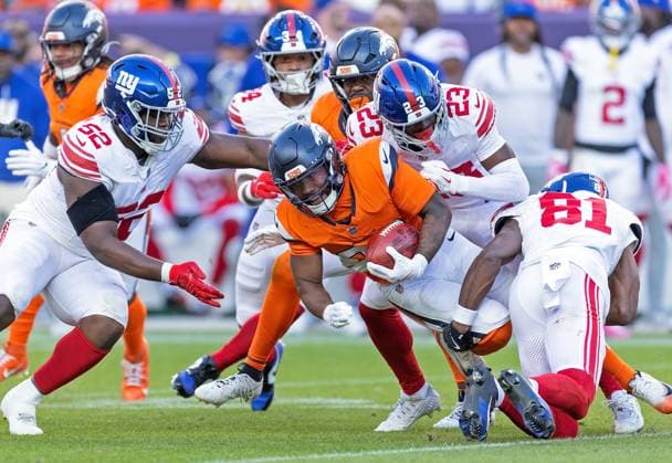 October 19, 2025, Denver, Colorado, USA: Broncos RB J.K. DOBBINS gets gang tackled by the Giants Defense after a long run during the 2nd. Half at Empower Field at Mile High Sunday afternoon. Broncos beat the Giants 33-32. Denver USA - ZUMAav4_ 20251019_zaf_av4_025 Copyright: xHectorxAcevedox
