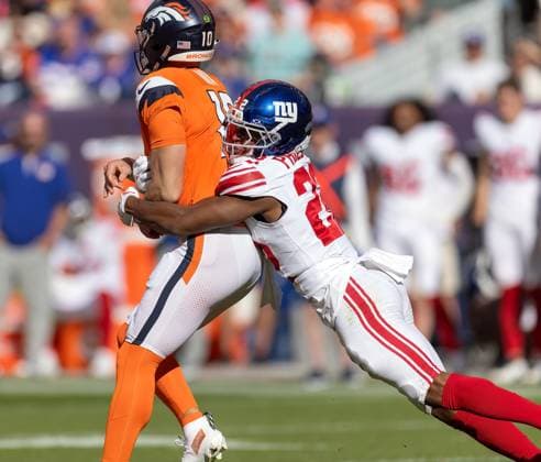 October 19, 2025, Denver, Colorado, USA: Broncos QB BO NIX gets hit from behind after he throws a pass during the 1st. Half at Empower Field at Mile High Sunday afternoon. Broncos beat the Giants 33-32. Denver USA - ZUMAav4_ 20251019_zaf_av4_035 Copyright: xHectorxAcevedox