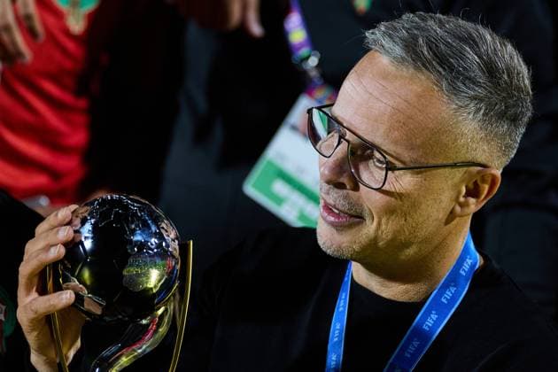 (251020) -- SANTIAGO, Oct. 20, 2025 -- Mohamed Ouahbi, head coach of Morocco, holds the trophy after the final match between Argentina and Morocco at the FIFA U-20 World Cup Chile 2025 in Santiago, Chile, Oct. 19, 2025. ) (SP)CHILE-SANTIAGO-FOOTBALL-FIFA U20 WORLD CUP-FINAL MengxDingbo 
