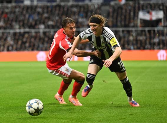 Anthony Gordon of Newcastle United goes past Amar Dedic of Benfica Newcastle United v Benfica, UEFA Champions League, Group Stage, Football, St James Park, Newcastle, UK - 21 Oct 2025Newcastle St James Park United Kingdom EDITORIAL USE ONLY No use with unauthorised audio, video, data, fixture lists, club league logos or live services. Online in-match use limited to 120 images, no video emulation. No use in betting, games or single club league player publications.  Copyright: xRichardxLee Shutterstockx 15552303v