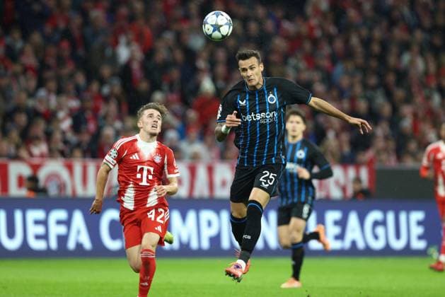 Bayern s Lennart Karl and Club s Aleksandar Stankovic fight for the ball during a game between German club FC Bayern Munchen and Belgian soccer team Club Brugge, on Wednesday 22 October 2025 in Munich, Germany, on day three of the League phase of the UEFA Champions League tournament. BRUNOxFAHY  x137624444x