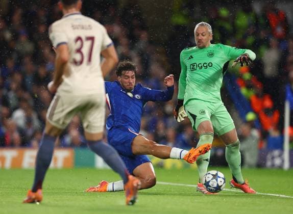London, England, 22nd October 2025. Remko Pasveer of Ajax (r) tackled by Marc Guiu of Chelsea (l) during the Chelsea vs Ajax UEFA Champions League match at Stamford Bridge, London. Picture credit should read: Paul Terry Sportimage EDITORIAL USE ONLY. No use with unauthorised audio, video, data, fixture lists, club league logos or live services. Online in-match use limited to 120 images, no video emulation. No use in betting, games or single club league player publications. SPI_016_PT_Chelsea_Ajax SPI-4230-0016