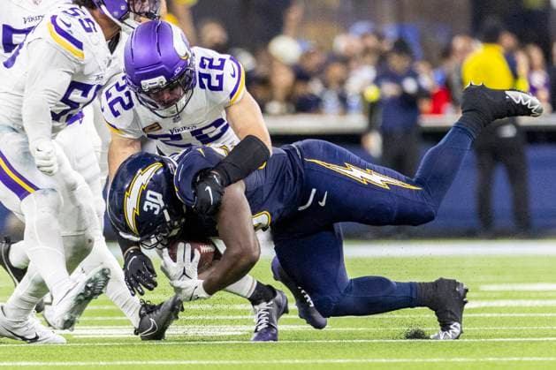 October 23, 2025, Los Angeles, California, USA: Los Angeles Chargers running back Kimani Vidal 30 is brough down by Minnesota Vikings safety Harrison Smith 22 during an NFL, American Football Herren, USA football game at SoFi Stadium, Thursday Oct. 23, 2025, in Inglewood, Calif. Los Angeles USA - ZUMAc68_ 20251023_zaf_c68_004 Copyright: xRingoxChiux