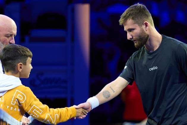 Corentin Moutet of France greets mascot by the net and shows tattoo on arm prior to the Quarter-finals match against Lorenzo Musetti of Italy at Erste Bank Open 2025 at Wiener Stadthalle on October 24, 2025 in Vienna, Austria. (Photo by Camilla Stolen, Imago) Vienna Austria Copyright: xCamillaxStolenx L1074130