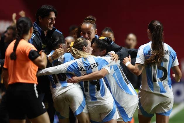 Argentina s midfielder Maricel Pereyra hidden C celebrates with head coach German Portanova L and teammates after scoring the team™s third goal during the CONMEBOL Women s Nations League football match, qualifier for the 2027 World Cup in Brazil, between Argentina and Paraguay, at the Diego Armando Maradona stadium in Buenos Aires, Argentina on October 24, 2025 BUENOS AIRES ARGENTINA Copyright: xALEJANDROxPAGNIx