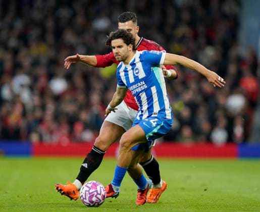 Manchester, England, 25th October 2025. Ferdi Kadıoglu of Brighton tussles with Diogo Dalot of Manchester United, ManU during the Manchester United vs Brighton and Hove Albion Premier League match at Old Trafford, Manchester. Picture credit should read: Andrew Yates Sportimage EDITORIAL USE ONLY. No use with unauthorised audio, video, data, fixture lists, club league logos or live services. Online in-match use limited to 120 images, no video emulation. No use in betting, games or single club league player publications. SPI_020_AY_Man_Utd_Brighton SPI-4237-0019