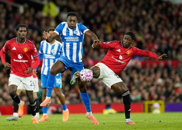 Manchester, England, 25th October 2025. Danny Welbeck of Brighton tackled by Kobbie Mainoo of Manchester United, ManU during the Manchester United vs Brighton and Hove Albion Premier League match at Old Trafford, Manchester. Picture credit should read: Andrew Yates Sportimage EDITORIAL USE ONLY. No use with unauthorised audio, video, data, fixture lists, club league logos or live services. Online in-match use limited to 120 images, no video emulation. No use in betting, games or single club league player publications. SPI_063_AY_Man_Utd_Brighton SPI-4237-0062