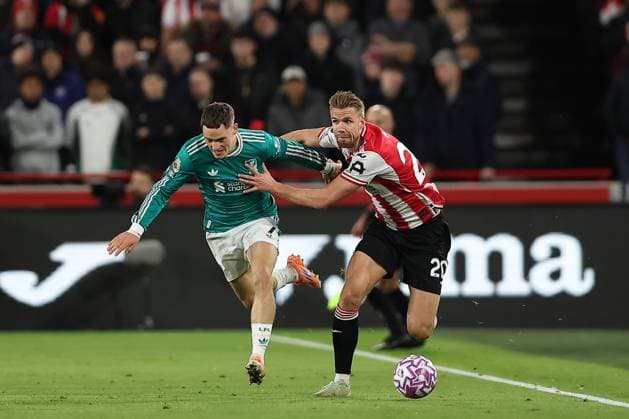 25th October 2025; Gtech Community Stadium, Brentford, London, England; Premier League Football, Brentford versus Liverpool; Florian Wirtz of Liverpool and Kristoffer Ajer of Brentford compete for the ball  KatiexChan