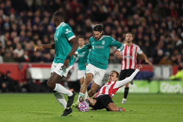 25th October 2025; Gtech Community Stadium, Brentford, London, England; Premier League Football, Brentford versus Liverpool; Dominik Szoboszlai of Liverpool tackled by Mikkel Damsgaard of Brentford  KatiexChan